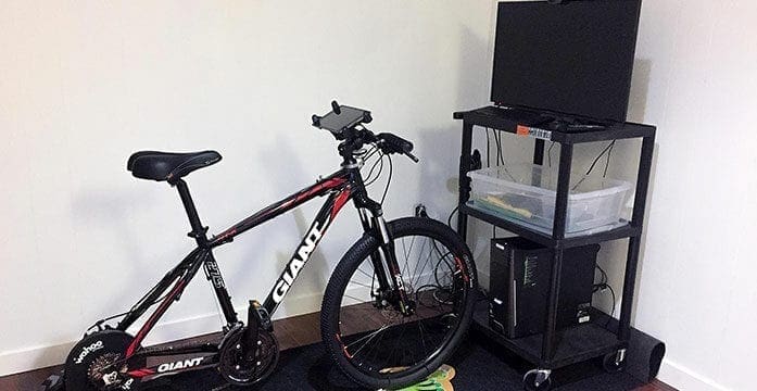 MedBIKE system stationary bike linked with tablet and video game Fitness program encourages kids with heart disease to train safely at home